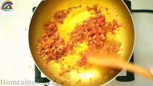 Add ginger garlic paste into translucent onion and cook until color gets light brown. At this point add chili powder, salt, paprika powder achar masala and leftover filling and saute for 11min.