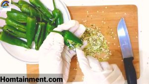 Preparation of green chillies for stuffing.